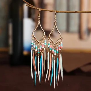 A pair of gold-toned diamond-shaped earrings with colorful beads and hanging plumes.