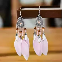 Drop earrings with a circular filigree top, dangling beads, and light-toned plumes.