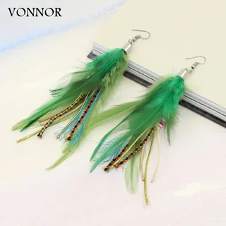 A pair of green feather drop earrings with braided, multi-colored cord accents on a white background.