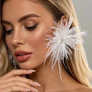 Cloud Nine Feather Earrings featuring a large, round burst of white plumes with a clear faceted center stone.