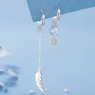 Asymmetric silver-tone earrings with one side featuring a long chain and feather charm, and the other featuring stone studs.