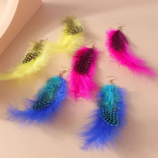 A collection of colorful, spotted plume feather earrings in blue, pink, and yellow.