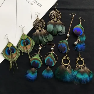 Collection of Garden Party Peacock Earrings featuring eye-shaped plumes and metal tree motifs.
