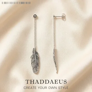 A pair of silver-toned chain threader earrings with a small metal feather charm at the end.