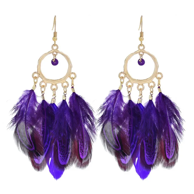 Purple feather earrings featuring a circular metal hoop top with hanging purple plumes.