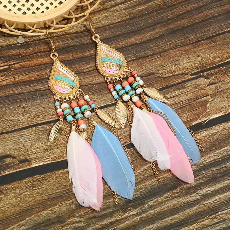 Drop earrings with patterned teardrop metal frames, multi-colored beads, and a mix of plumes and metallic leaf charms.