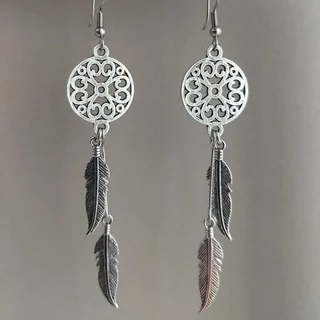 Silver-toned drop earrings featuring a circular openwork medallion and multiple hanging metal feathers.