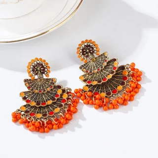 A pair of orange and dark red fan-shaped metal earrings with a bottom fringe of matching orange beads.