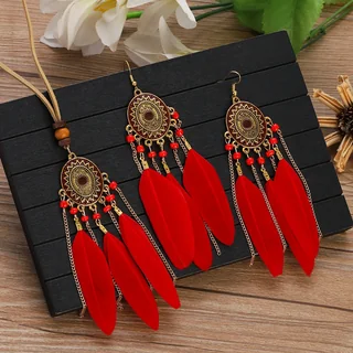 Sundial Feather Jewelry featuring geometric medallions with red plumes and chain accents.